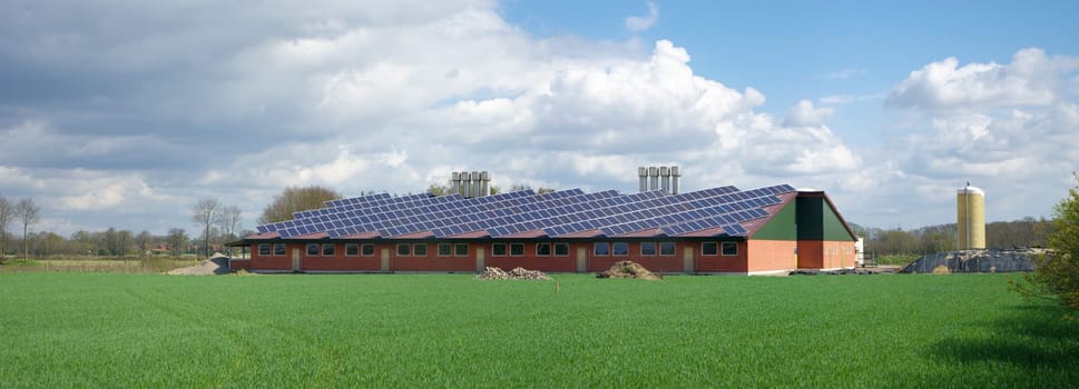 barn with its roof full with solar panels