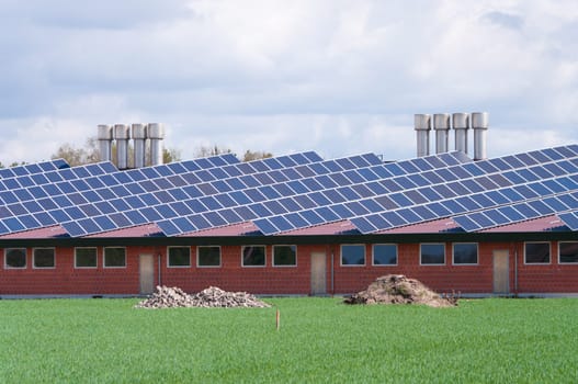 barn with its roof full with solar panels