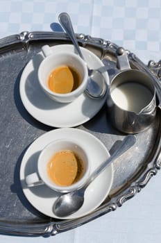 cups of coffee and milk with tray