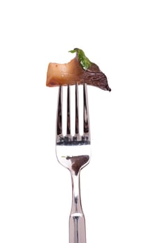 White isolated edible mushroom king oyster mushroom with parsley on a fork