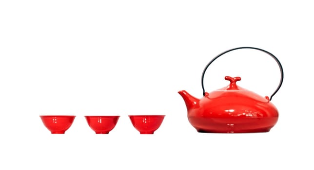 Red vintage kettle and three teacups isolated on white background. Clipping path included.