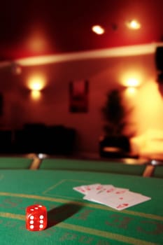 green casino table with dice and a hand of a royal flush in a poker game