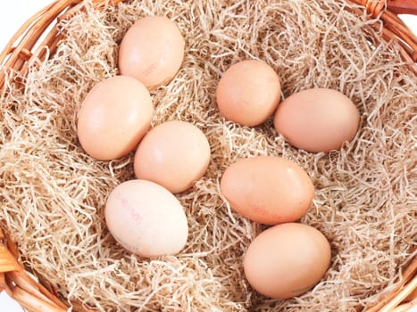 Eggs in a wicker basket with straw