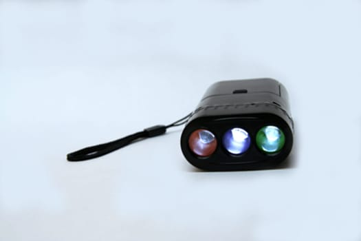 Miniature torchlight with triple lamps isolated on white background