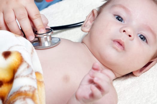 Stethoscope listening to a baby&#039 s heart beat