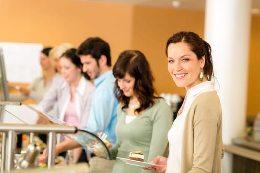 Cafeteria food young woman choose dessert self service buffet