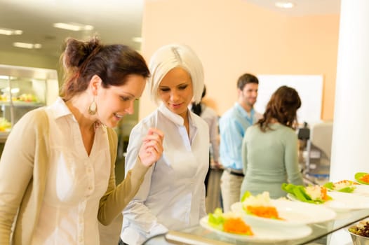 Lunch break business woman select meal from display cabinet canteen