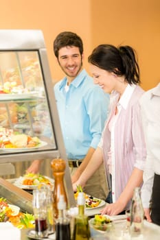 Cafeteria lunch young office colleagues choose salad self-service canteen