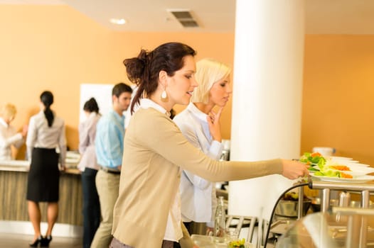 Lunch break business woman select meal from display counter canteen