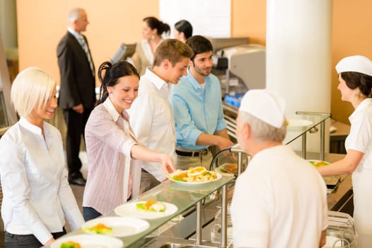 Business colleagues in cafeteria cook serve fresh healthy food meals