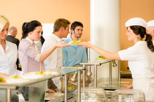 Business colleagues in cafeteria lunch-lady serve fresh healthy food meals