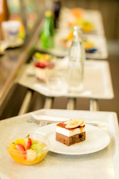 Desserts on serving tray cafeteria self service fruit salad cake