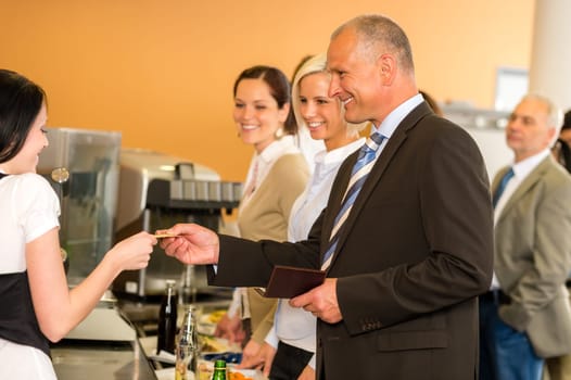 Cafeteria man pay by credit card cashier food on serving tray