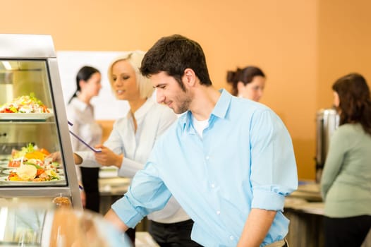 Business man take cafeteria lunch food from display cabinet self-service