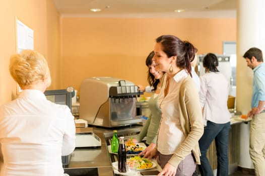Cafeteria woman pay at cashier hold serving tray fresh food