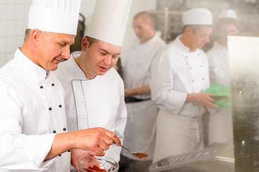 Professional kitchen chef cook add spice paprika prepare food meals