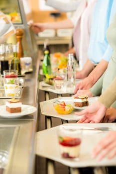 Desserts at cafeteria people with serving tray self service canteen