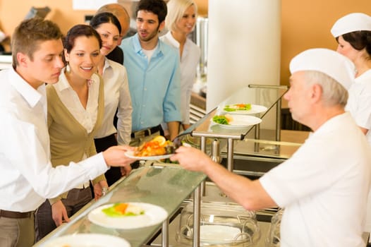Business colleagues in cafeteria cook serve fresh healthy food meals