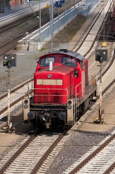 red locomotive in front of the train station in Lingen, Germany