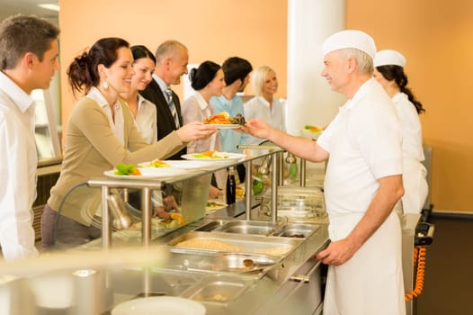 Business colleagues in cafeteria cook serve fresh healthy food meals