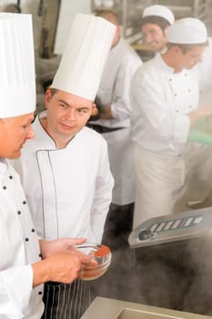 Professional kitchen chef cook add spice paprika prepare food meals