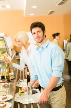 Young businessman at cafeteria hold serving tray canteen self-service