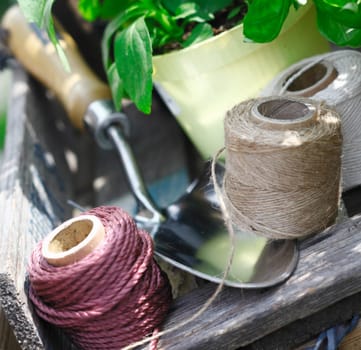 Closeup of balls of twine of varying thickness used for tying up plants