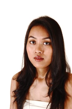 A closeup shoot of a pretty Asian girl with long black hair, looking into the camera for white background.