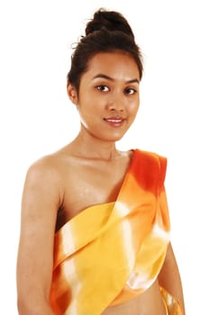A pretty woman from Asia standing in the studio with a colorful scarf around her slim body, for white background.