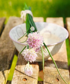 Flowering Chives on old and vintage wooden Table