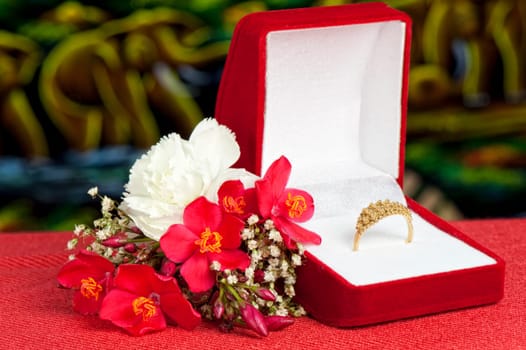 a Arrangement with flowers and wedding rings