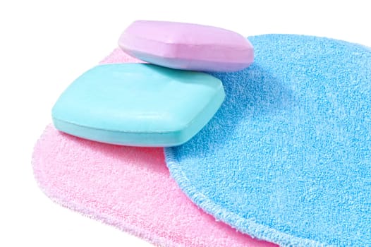 bath sponges in three different colors on white background