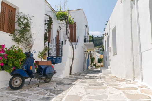 Classical narrow street with a painted sidewalk in Parikia