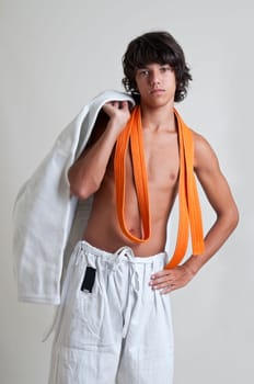 Young fighter posing isolated against a light backgroud