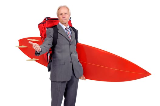 Mature businessman hitchhiking with backpack and surf board