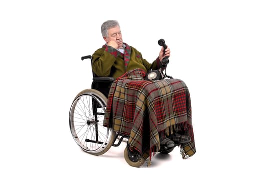 Lonely elderly in a wheelchairstaring at the phone