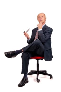 Mature businessman in a chair with a pipe