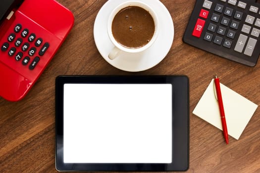 Workplace with blank pc tablet, telephone,calculator, pen and cup of coffee
