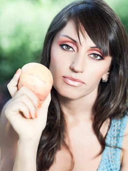 Beautiful woman with apple outdoor