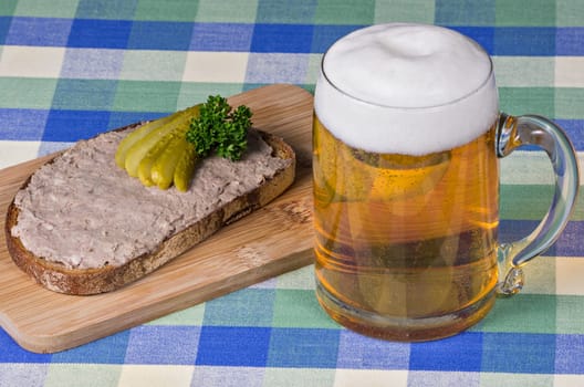 Hearty snack with liver sausage bread and beer
