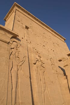 Carving of Egyptian god on pylon in Temple of Isis at Philae, Egypt