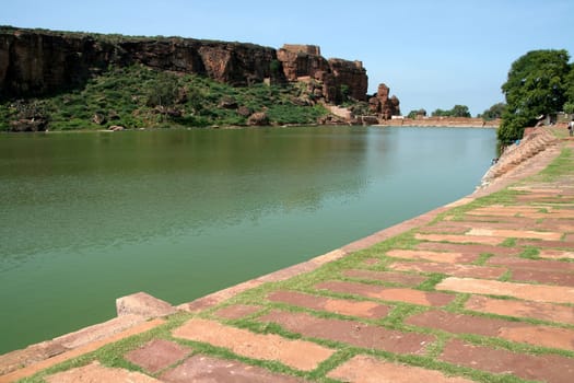 Lake Agusthya Teertha at Badami (with southern hill in background and dressed stone bund in foreground), Karnataka, India, Asia