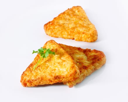 3 Potato Rosti isolated on white with parsley