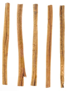 five cinnamon sticks isolated on white. High angled cinnamon sticks on white background.