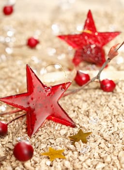 Red vitreous Christmas stars and two golden on a festive christmas background