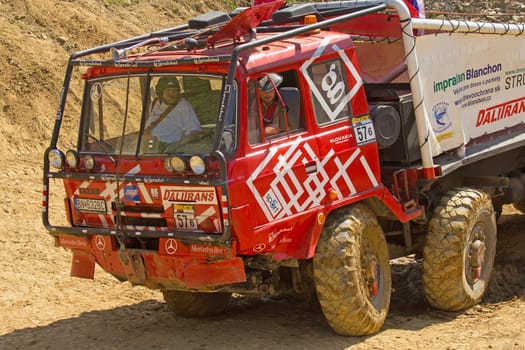 MOHELNICE, CZECH REPUBLIC - MAY 20. Unidentified racer in red truck passes through difficult terrain in the "Grand Prix Truck Trial 2012"" on May 20, 2012 in the town of Mohelnice, Czech Republic."