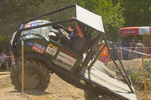 MOHELNICE, CZECH REPUBLIC - MAY 20. Unidentified racer at green truck passes through difficult terrain in the "Grand Prix Truck Trial 2012"" on May 20, 2012 in the town of Mohelnice, Czech Republic."