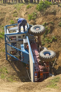 MOHELNICE, CZECH REPUBLIC - MAY 20. Unidentified racer flipped his truck on its side in the "Grand Prix Truck Trial 2012"" on May 20, 2012 in the town of Mohelnice, Czech Republic."