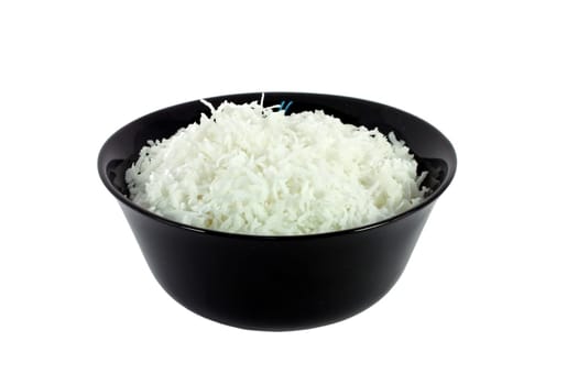 Black bowl full of coconut meal isolated on white
