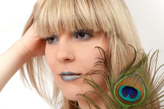 Young woman with peacock feather